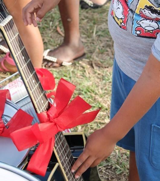 Voluntários entregam instrumentos para projeto de música no bairro Renascer